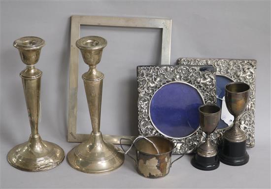 A pair of silver tapered candlesticks (weighted) and sundry items,